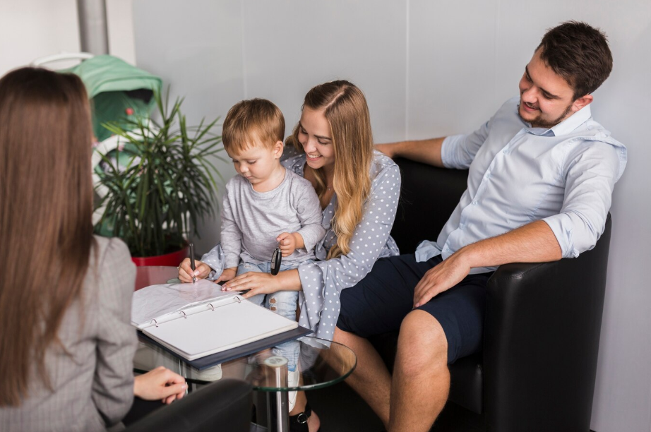 Young family meeting with financial advisor to discuss generational wealth strategies and legacy planning for their child.