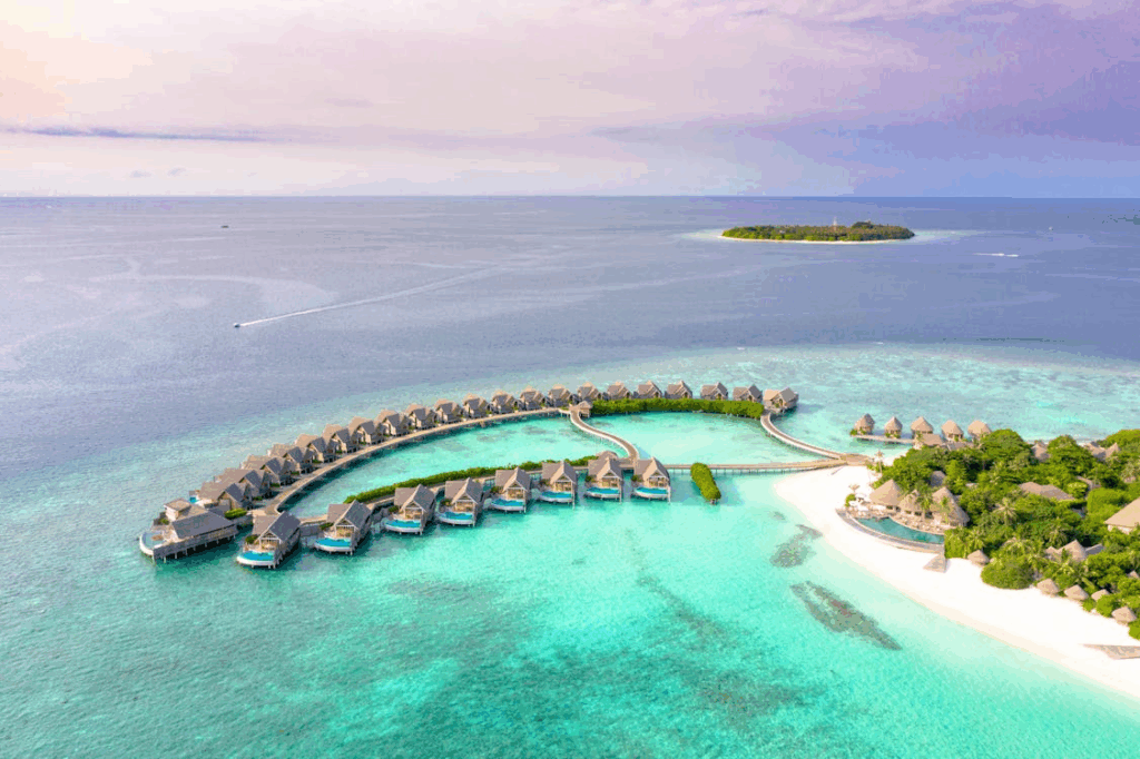 Overwater villas on a private island resort surrounded by turquoise ocean waters, ideal for a secluded island getaway