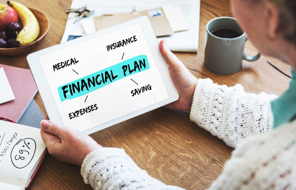Person reviewing digital financial plan on tablet with focus on insurance, savings, medical, and expenses before turning 40.