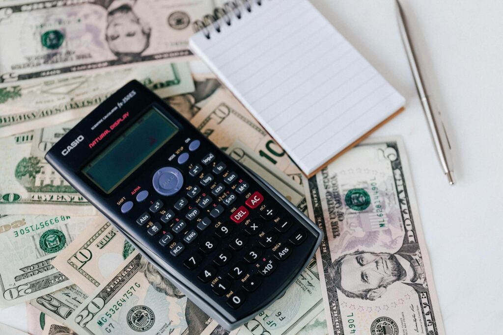 calculator and notepad with US dollars